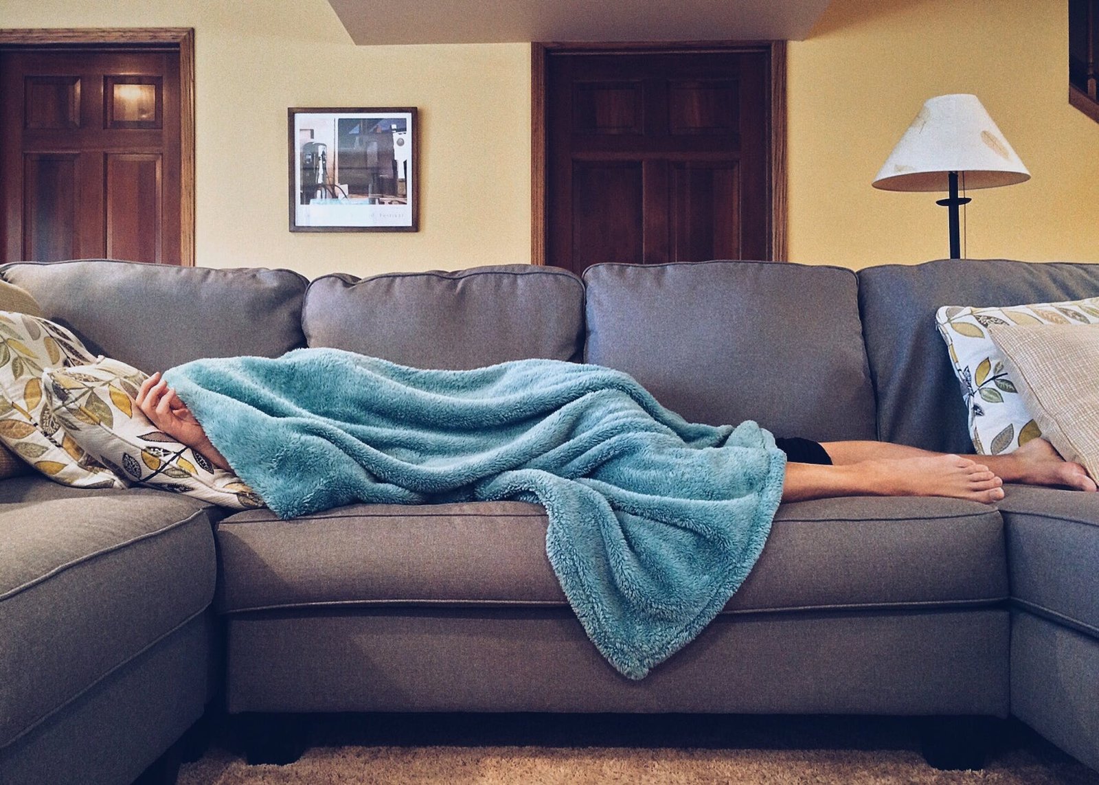 Person Lying on Sofa with stomach illness