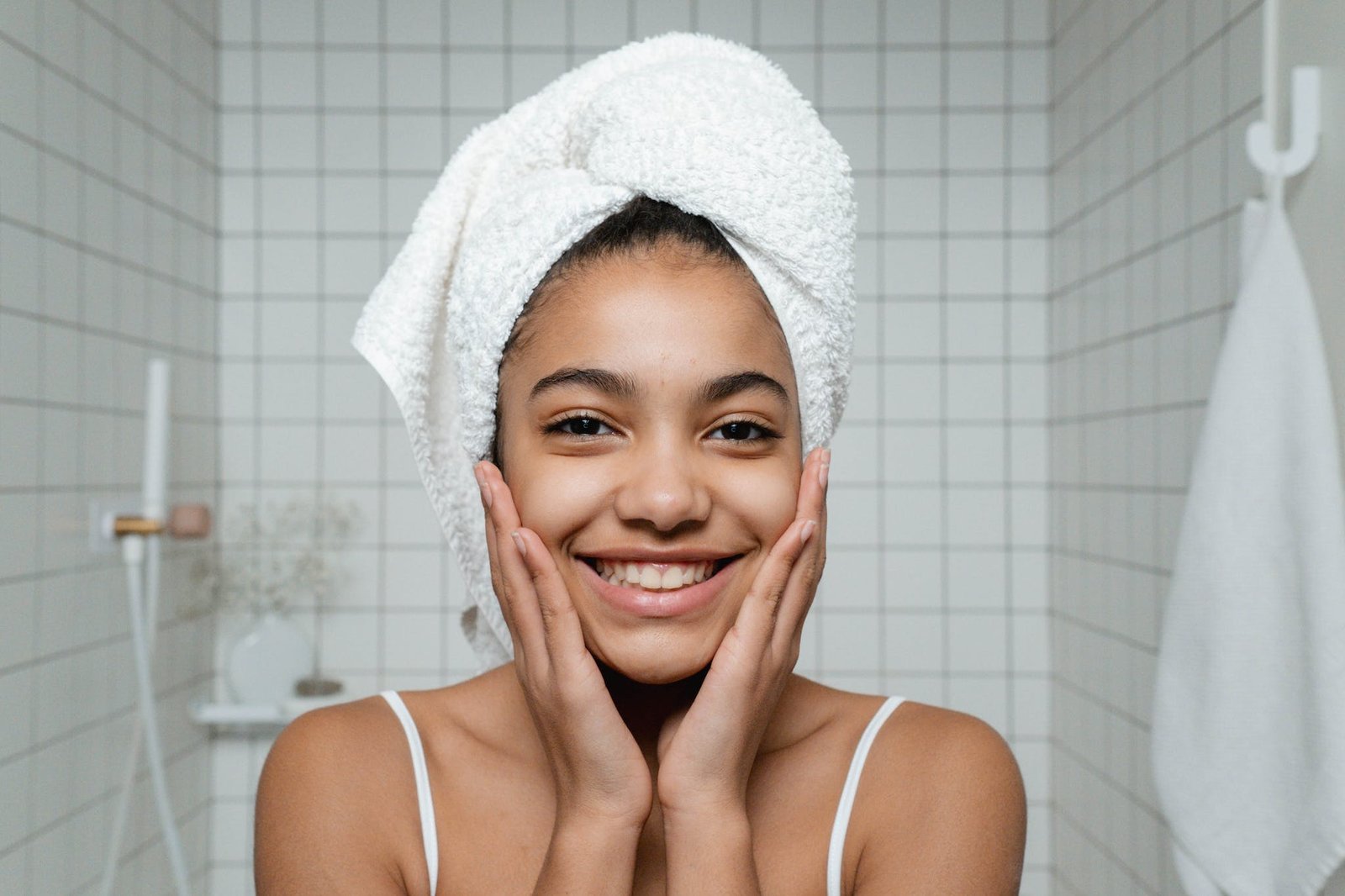 Smiling Young Woman in White Spaghetti StrapTop with healthy skin
