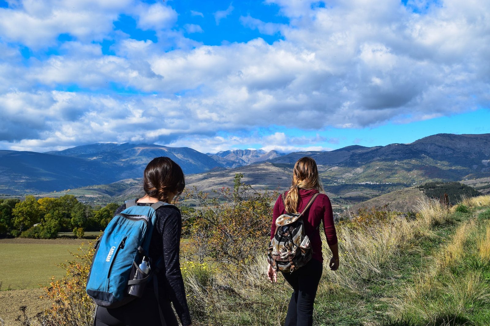 Two Women Walks to Open Field hiking Backpacking Water Bottles