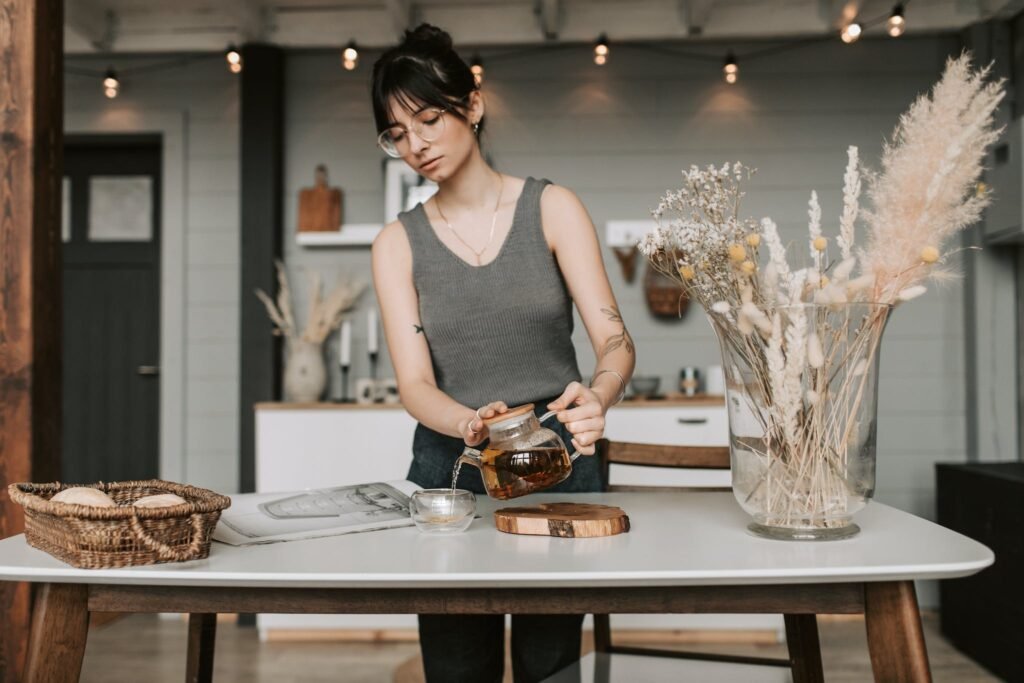 Woman in Gray Tank Top Pouring Teas