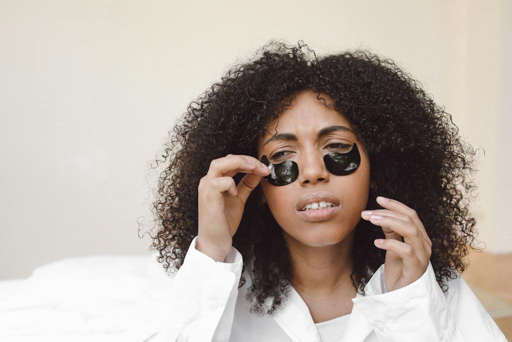 A Woman Putting an Under Eye Mask