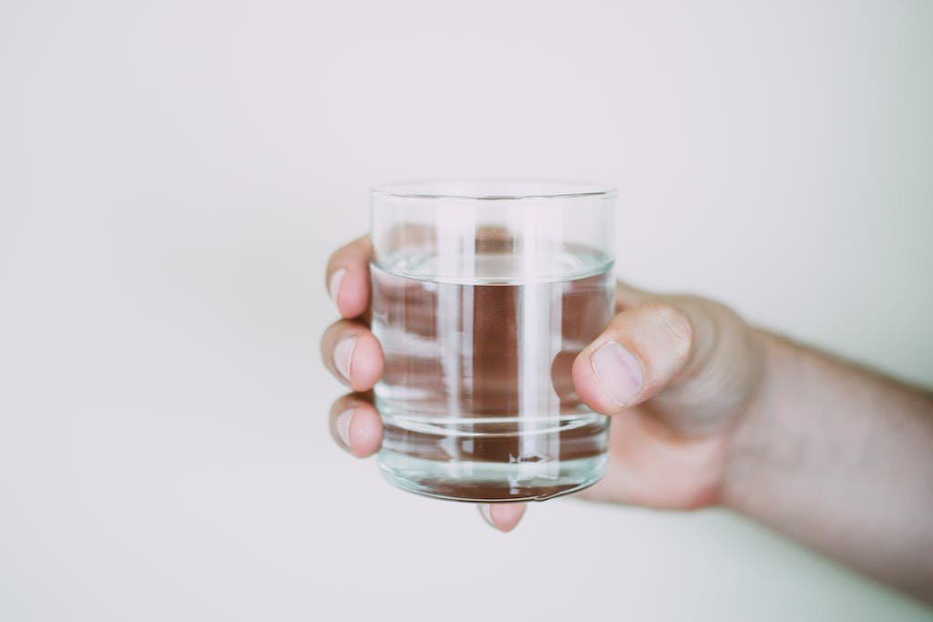 Person Holding Drinking Glass