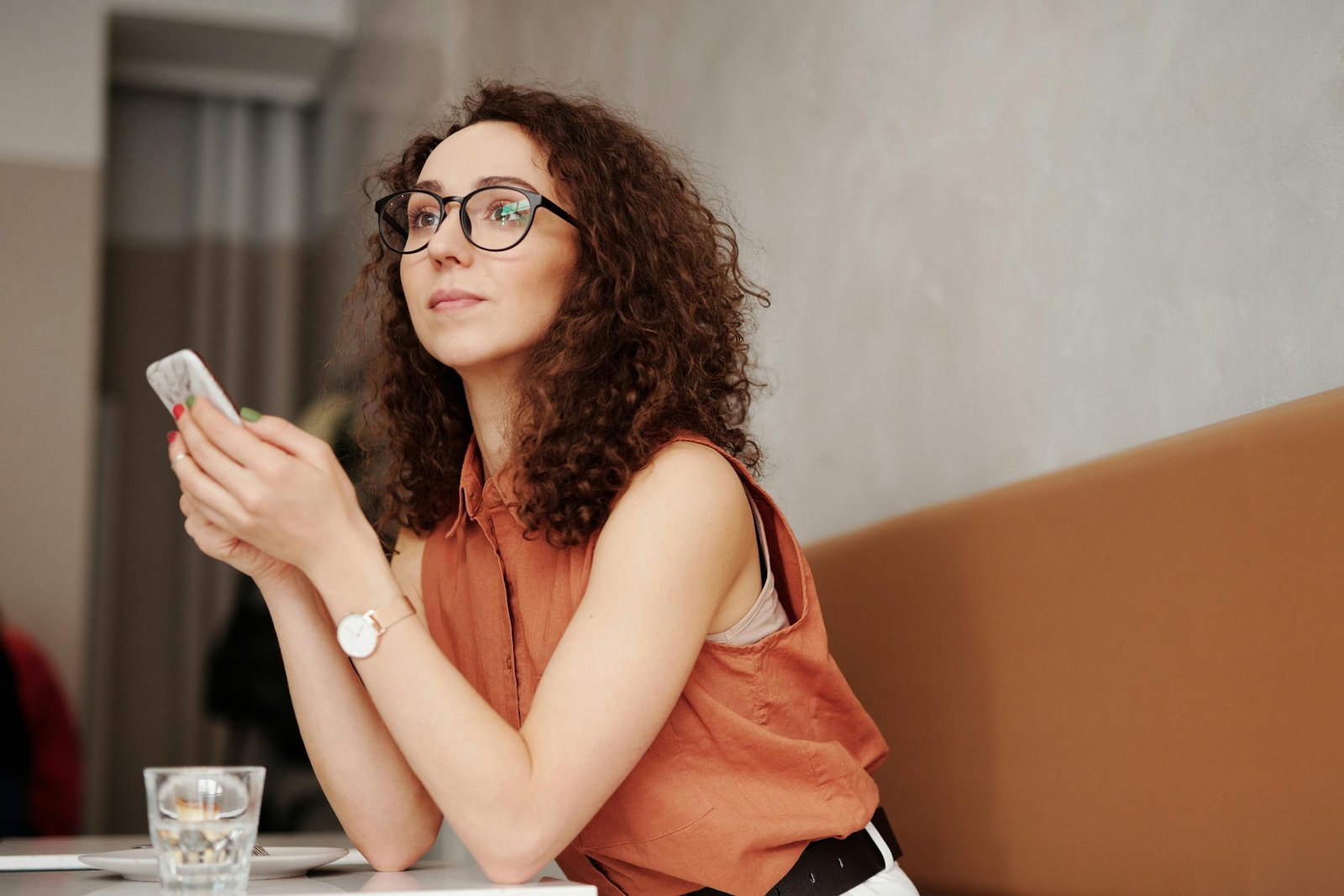 Woman in Red Tank Top Wearing Black Framed Eyeglasses